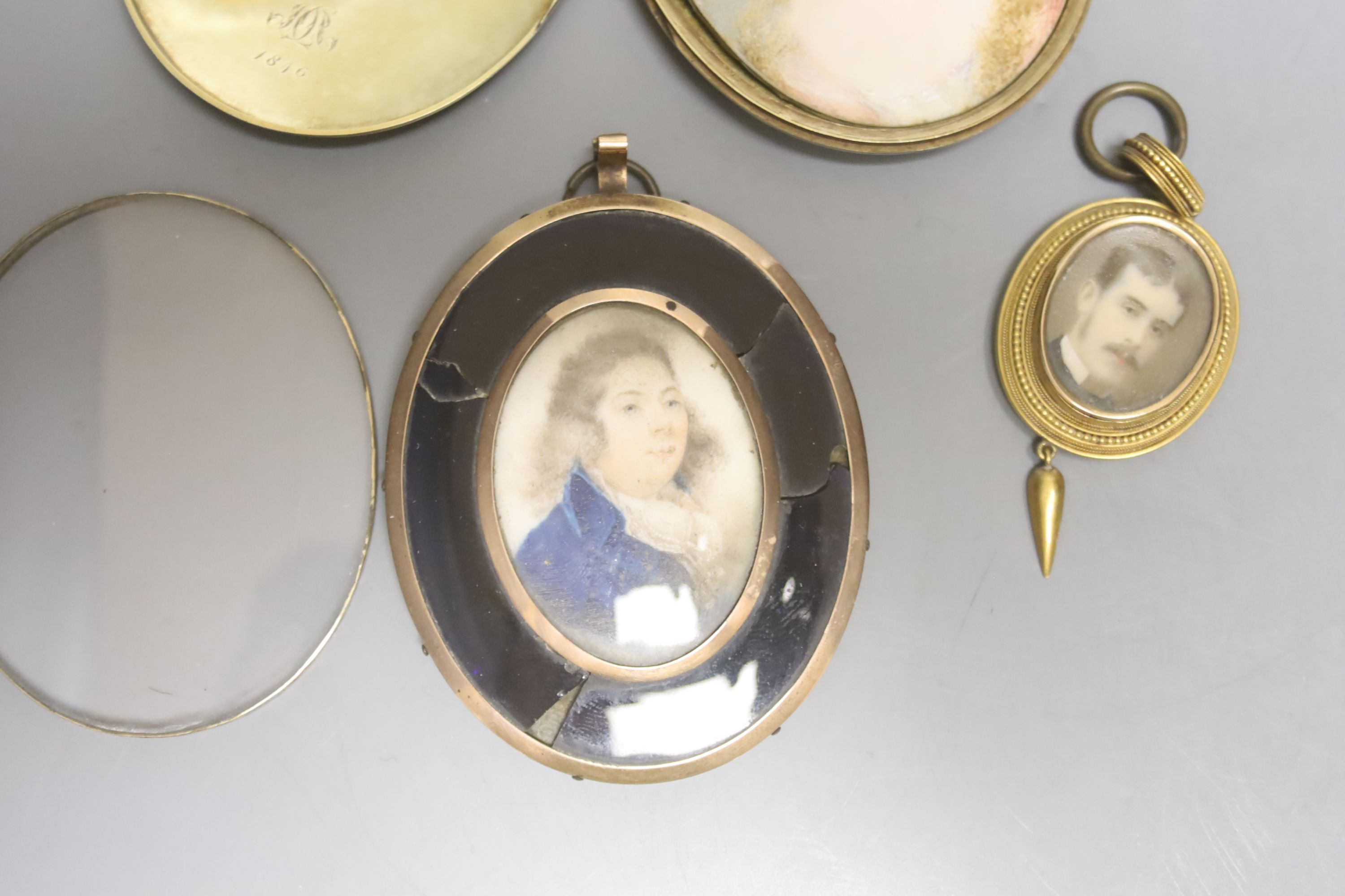 Three 19th century yellow metal mounted and cased portrait miniatures on ivory, one blue enamelled